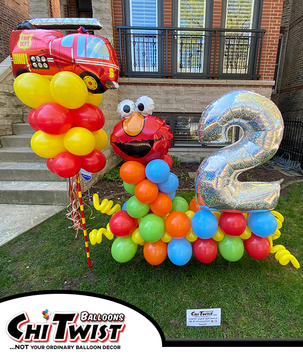 Marquee & Balloon Pole Display with Elmo and a fire truck